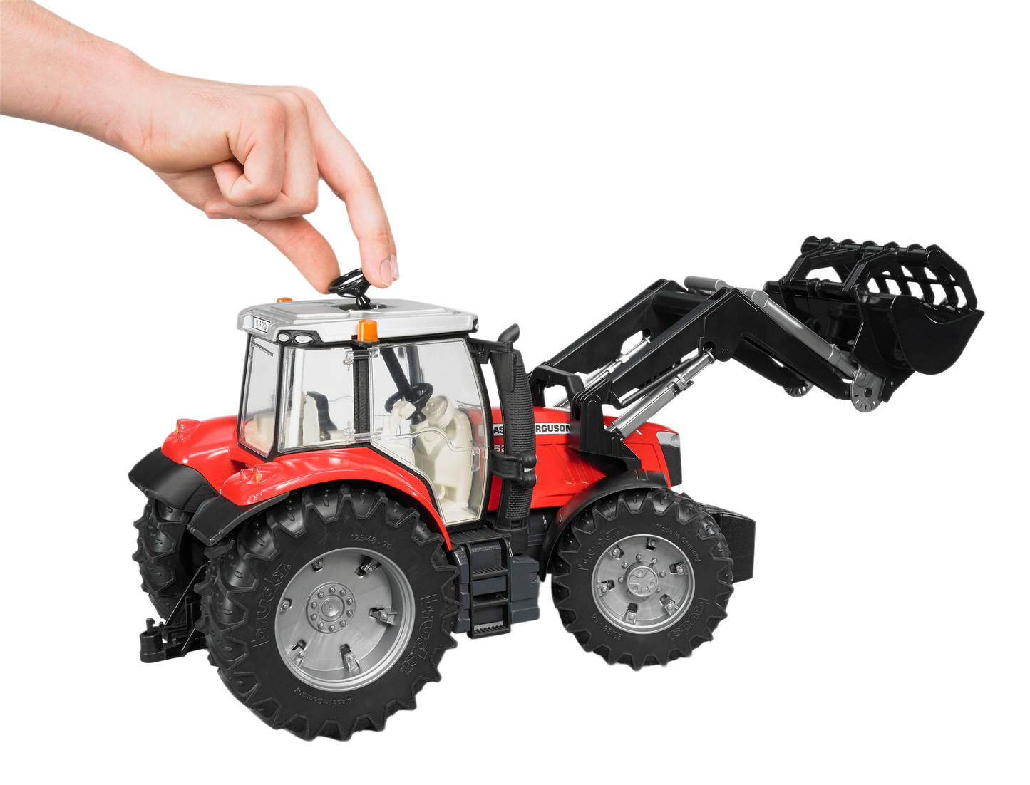 Hand operating detailed red Bruder Massey Ferguson 7624 toy tractor with frontloader in Vehicles & Remote Controlled Toys collection