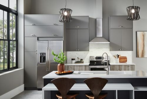 Modern kitchen featuring stainless steel pyramidal chimney hood with LED lights and dark gray cabinetry in home improvement setting