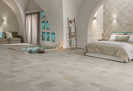 Indoor bedroom and lounge space with beige matte porcelain tiles, arched walls, and soft neutral decor for flooring and home improvement
