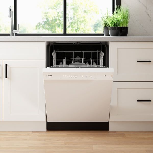 Open white Bosch 24-inch dishwasher installed in modern kitchen cabinetry with black handles and potted herbs on counter