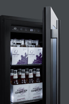 18" built-in beverage cooler with black finish and tinted glass door, stocked with bottled drinks inside kitchen setting