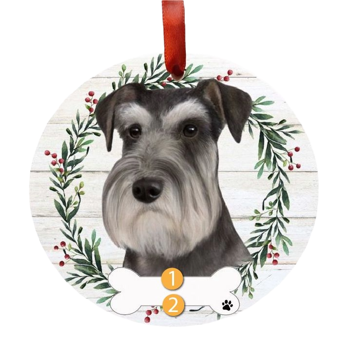 Round Christmas ornament with Schnauzer dog face surrounded by green and red berry wreath and red hanging ribbon