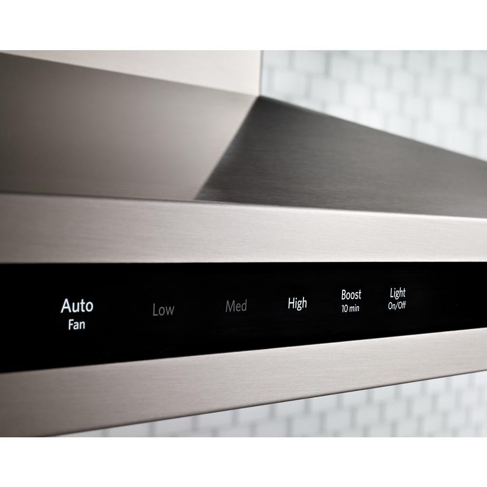 Close-up of stainless steel canopy hood control panel showing Auto Fan, speed settings, boost timer, and light switch in kitchenware collection