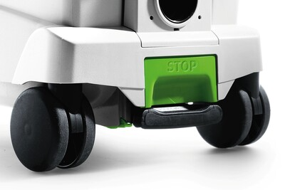 Close-up of black caster wheels and green stop lever on a Festool dust extractor in woodworking tools collection