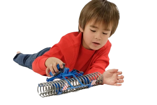 Young child playing with a blue and silver model front furrow press toy for tools and home improvement projects