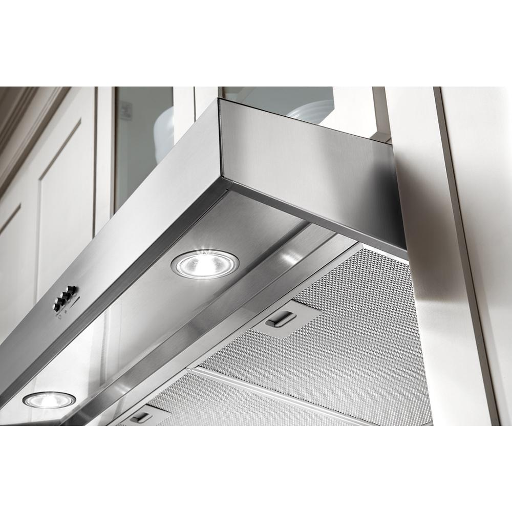 Close-up of stainless steel range hood with LED lights and full-width grease filters for kitchen and home improvement.