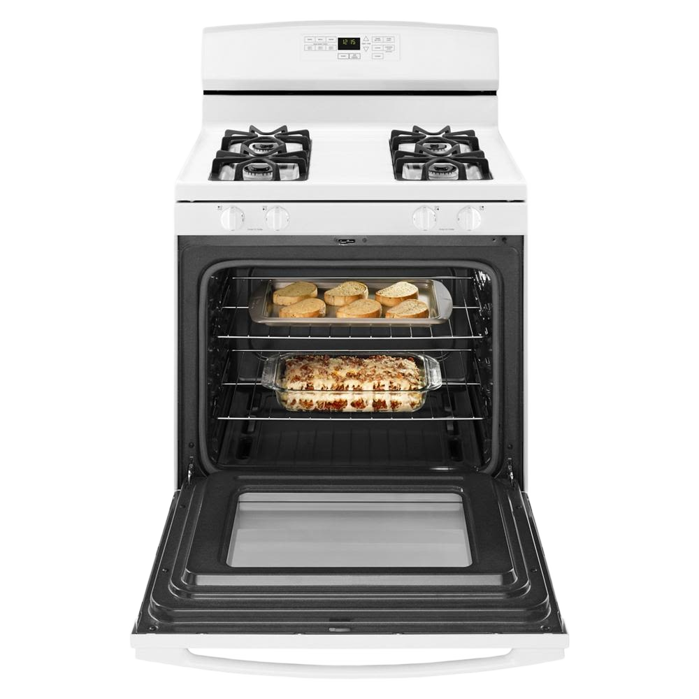 White 30-inch gas range with four burners and open oven showing baked dishes in kitchen appliances collection