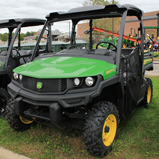 Green and yellow John Deere full-size crossover utility vehicle with rugged tires for outdoor and home improvement tasks