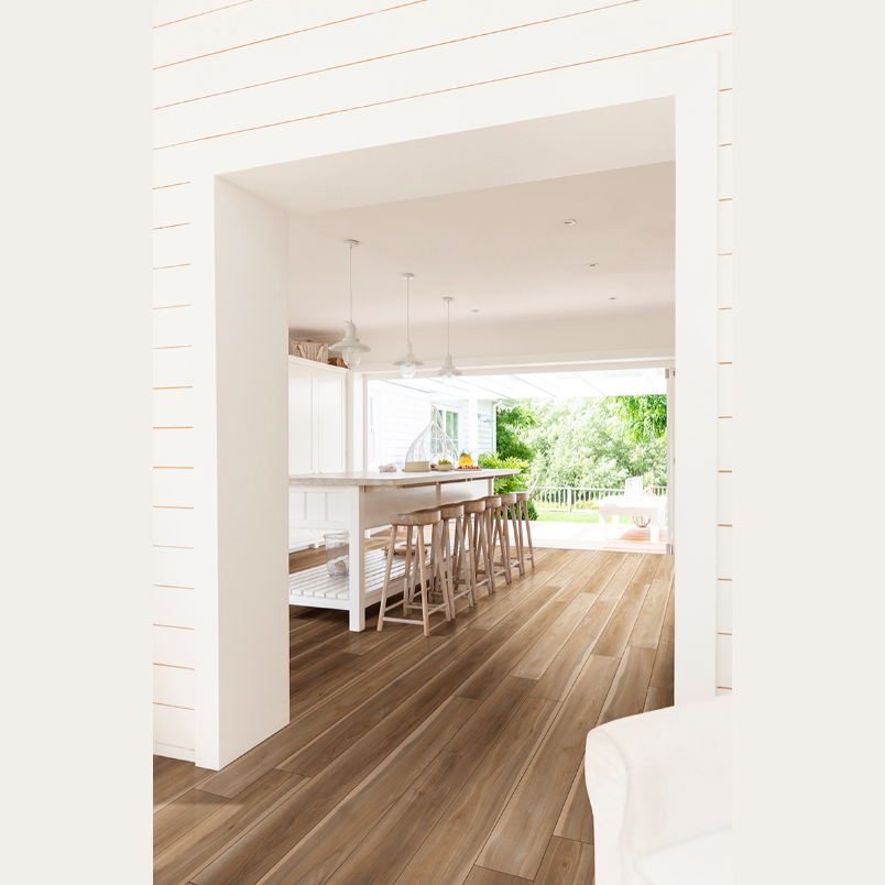 Spacious bright kitchen with wood-look luxury vinyl tile planks in warm blonde tones from vinyl flooring collections