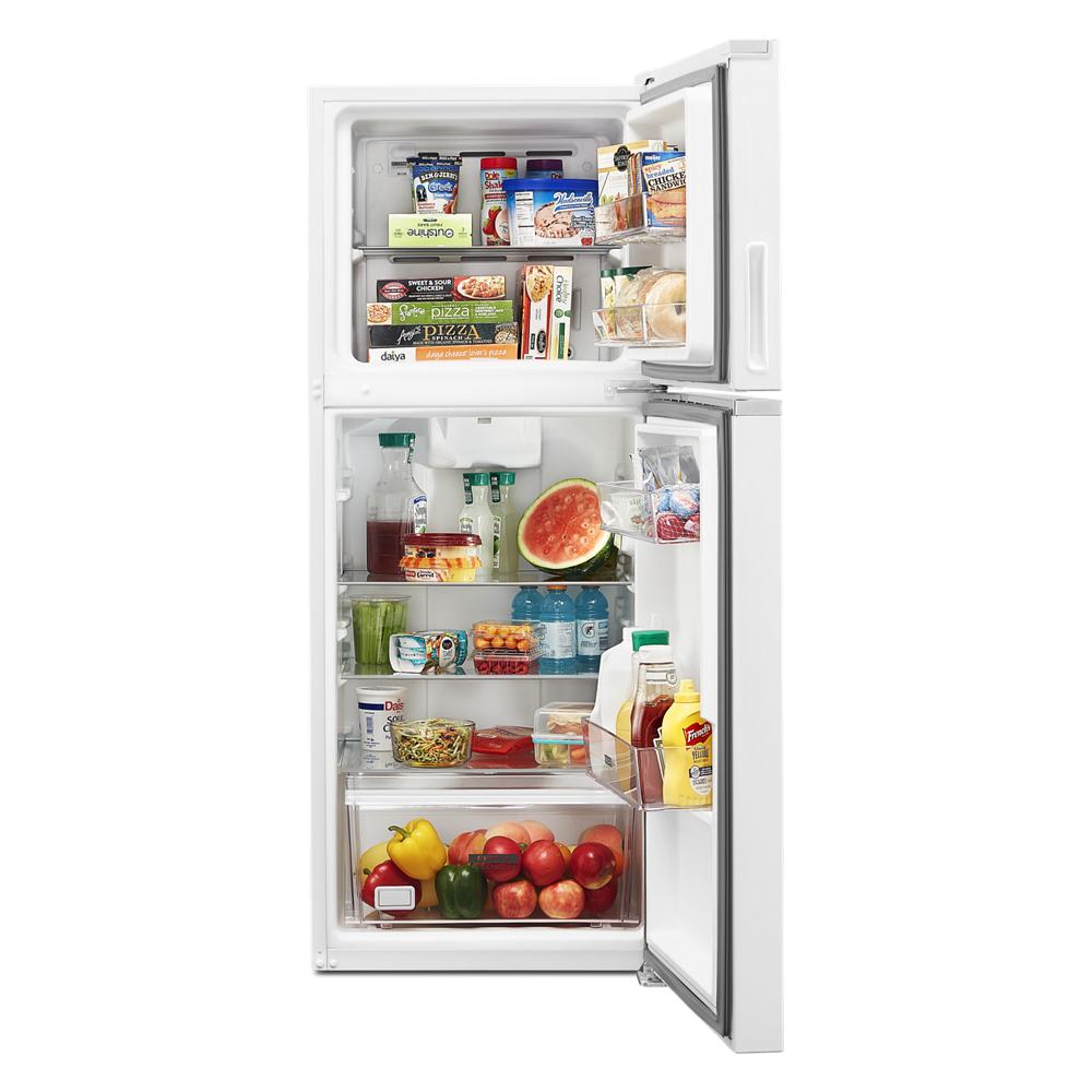 White top-freezer refrigerator with organized shelves holding food and beverages in kitchen appliance setting