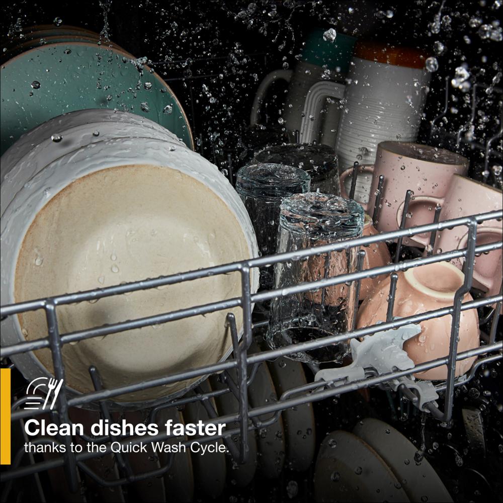 Dishes and glassware being washed with water spraying inside a built-in dishwasher from kitchenware collection