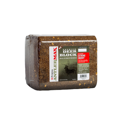 Rectangular compressed deer feed block with printed label highlighting extreme energy formula for wildlife nutrition