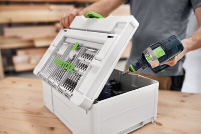 White and green Festool Systainer3 with transparent lid compartment holding drill bits and power tool for workshop organization
