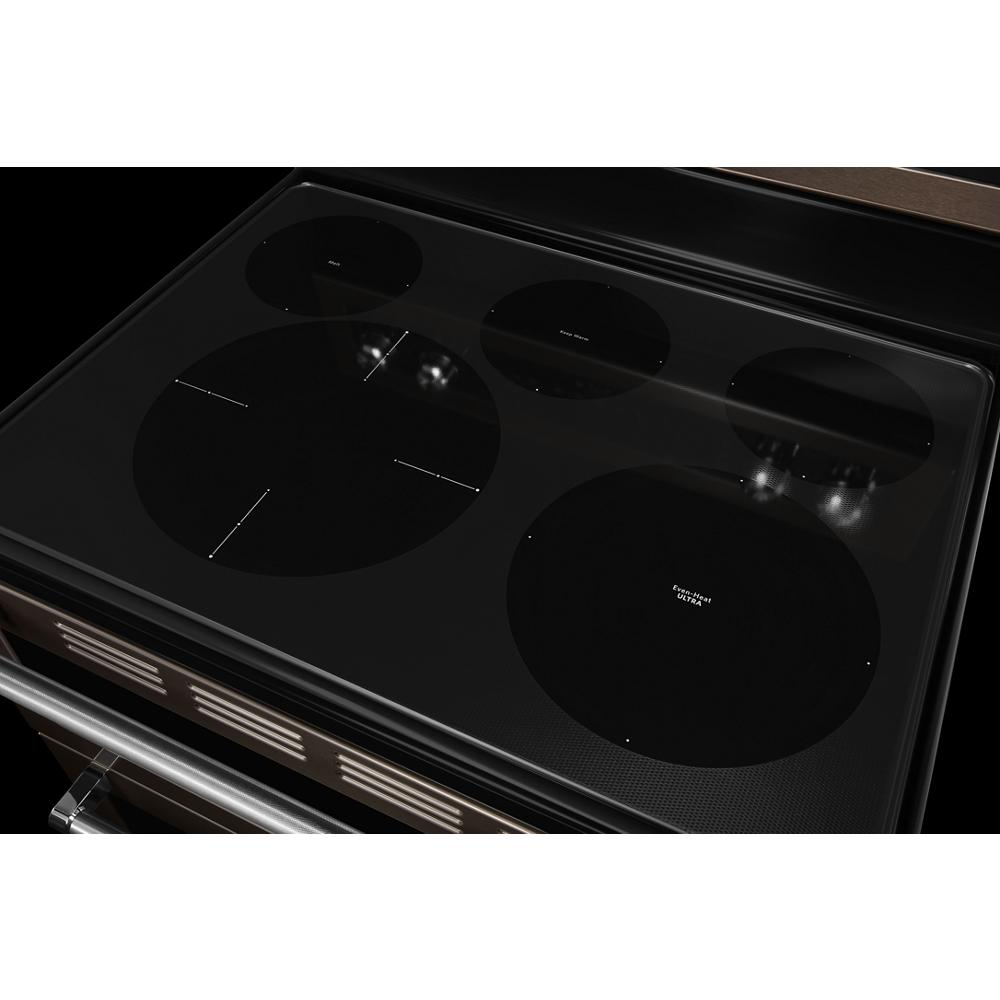 Smooth black electric cooktop with five induction burners and touch-sensitive controls in kitchen appliances category