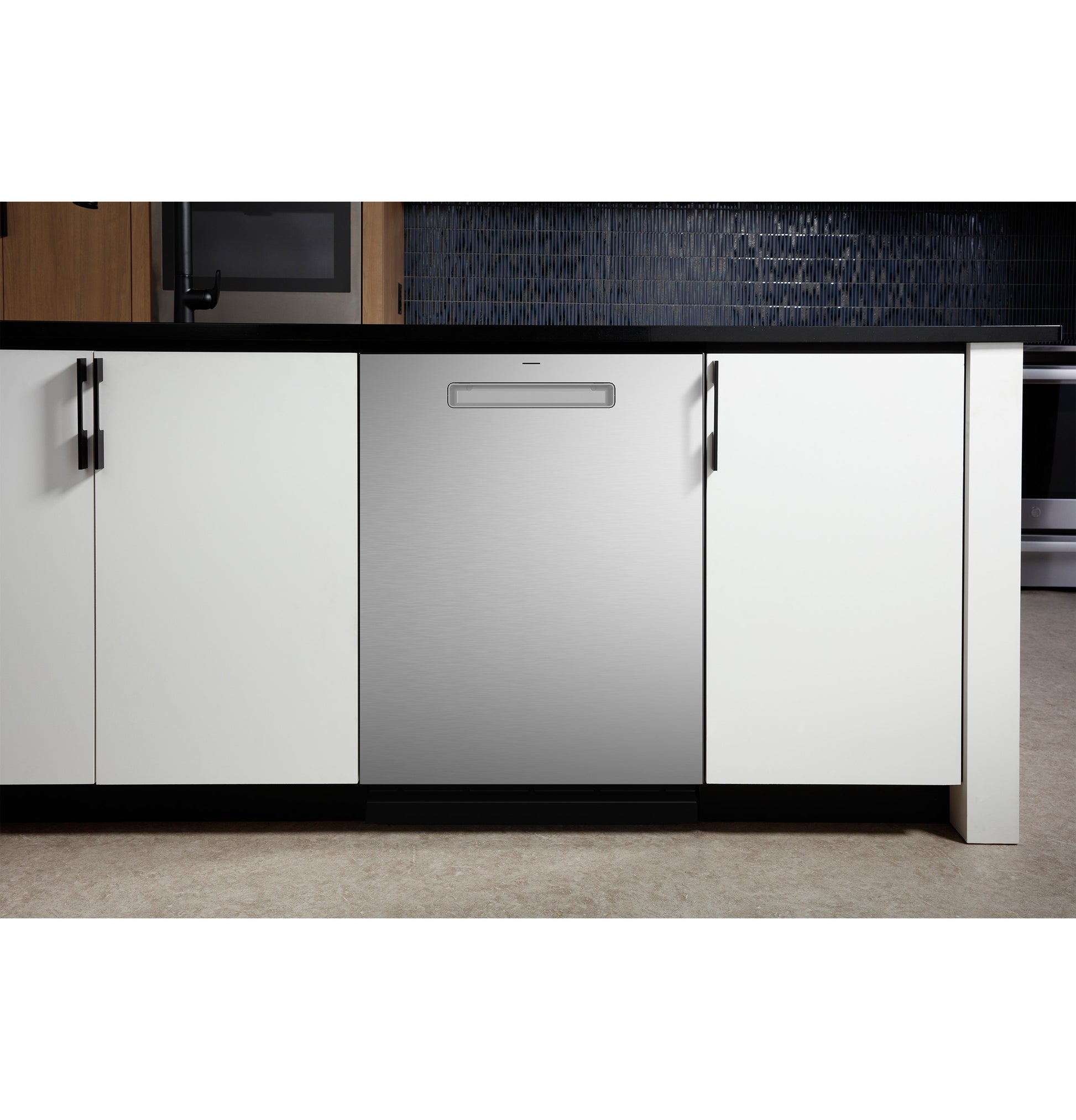 Built-in stainless steel dishwasher with discreet handle integrated into modern white kitchen cabinetry in appliance setting