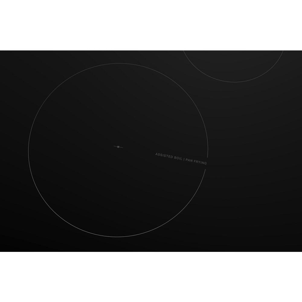 Close-up of black induction cooktop surface showing subtle outline of cooking zones with WipeClean™ coating.