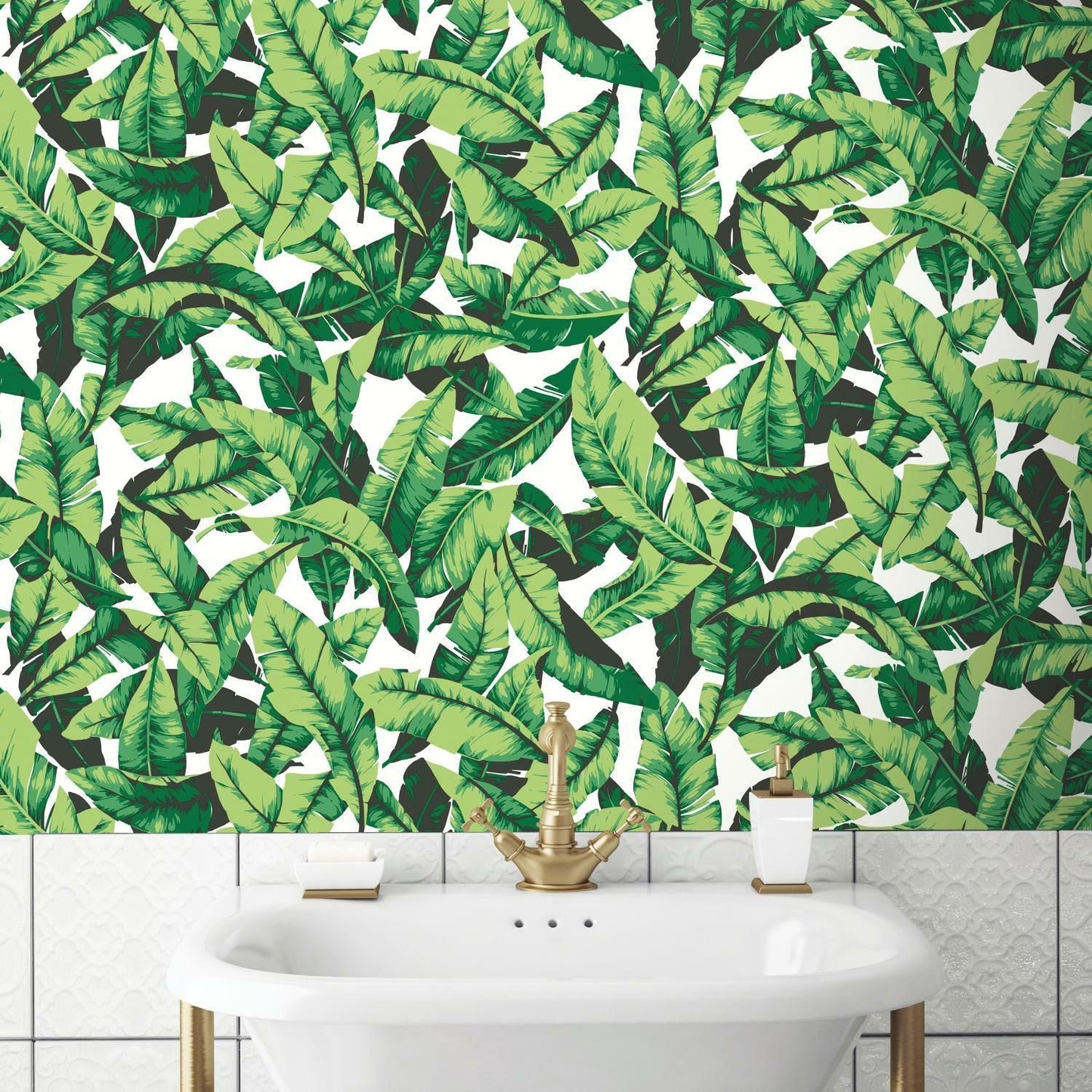Green tropical palm leaf pattern peel and stick wallpaper installed above white bathtub with gold faucet