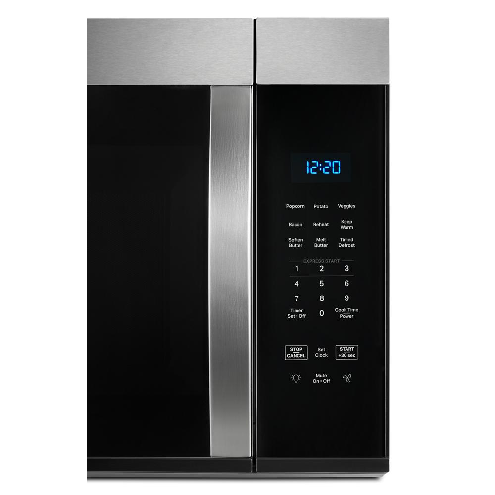 Close-up of a stainless steel over-the-range microwave control panel with digital clock and preset cooking buttons