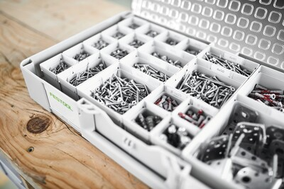 White Festool organizer with clear lid and multiple compartments holding assorted screws for workshop tool storage