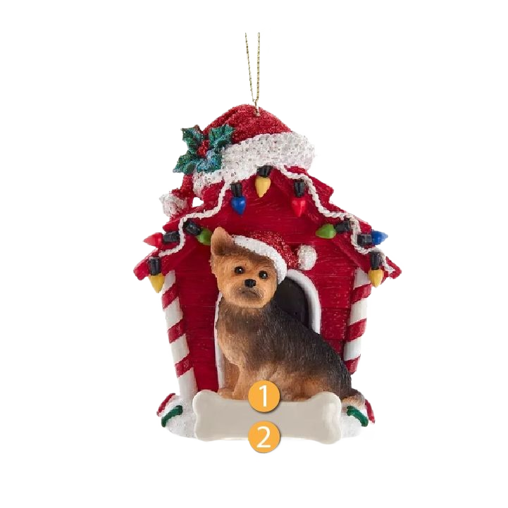 Decorative Yorkshire Terrier figurine in Santa hat sitting in front of a red dog house adorned with holiday lights