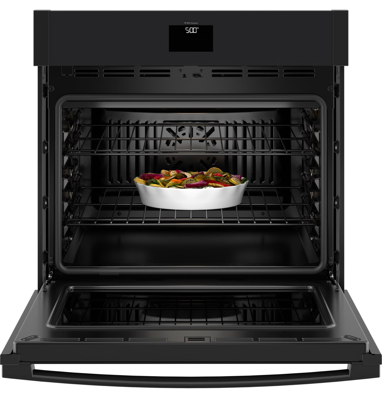 Open black built-in wall oven with digital display and vegetable dish inside from kitchen appliances collection