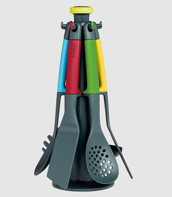 Set of colorful kitchen utensils on a rotating stand featuring various cooking tools for home use and play