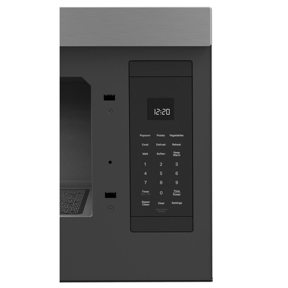 Built-in microwave control panel with digital clock and touchpad buttons for cooking, defrosting, and timer functions