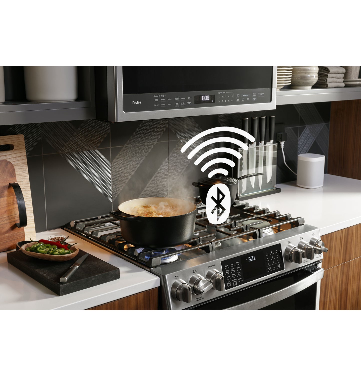 Modern stainless steel gas range with front controls and Bluetooth connectivity cooking in a contemporary kitchen setup
