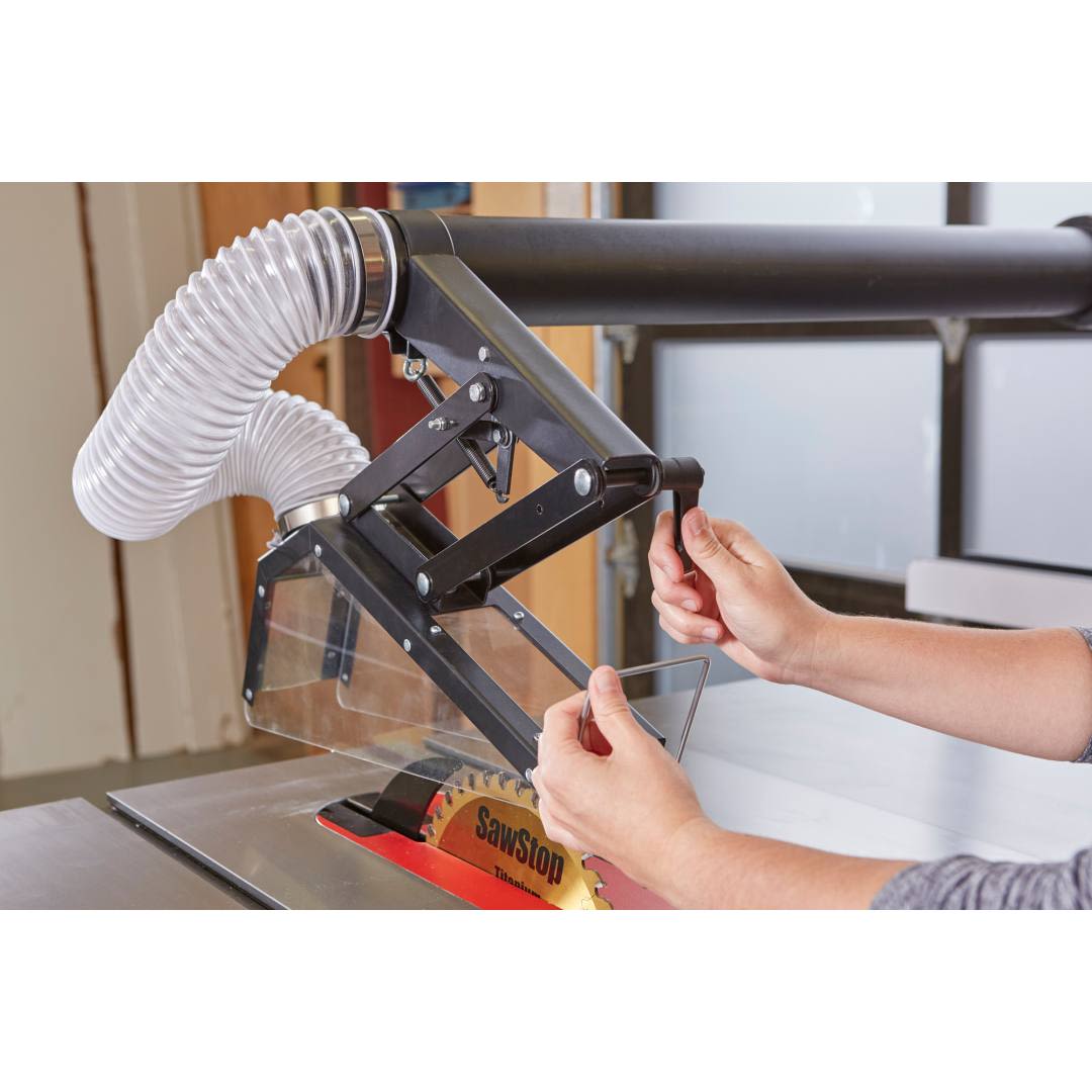 Adjustable floating overarm dust guard with clear shield and flexible hose for improved saw safety and dust control in tool accessories