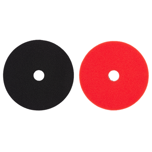 Two 5-inch foam polishing pads in black and red with center holes for woodworking tool accessories and finishing tasks