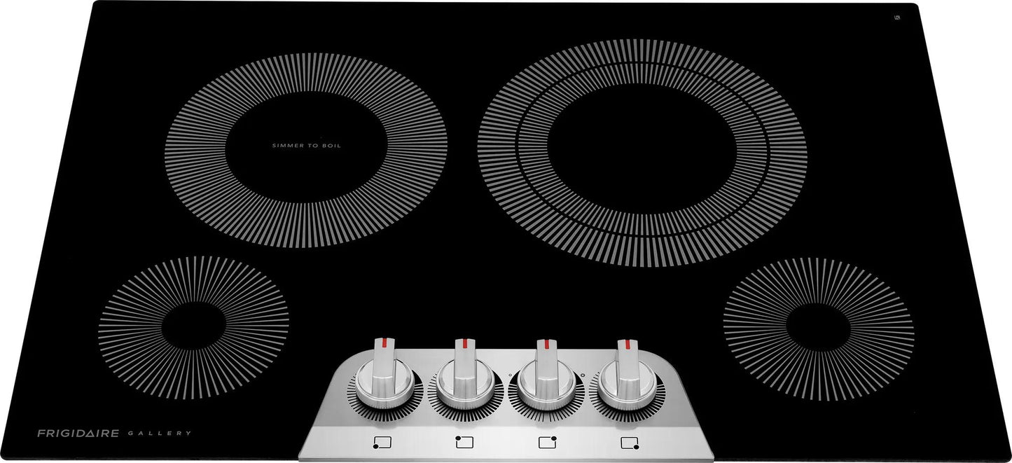 Black electric cooktop with four circular heating zones and silver control knobs in kitchen appliances collection