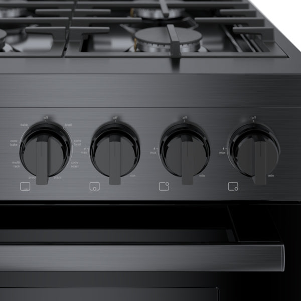 Close-up of black stainless steel dual fuel range control panel featuring four heavy-duty metal knobs for precise cooking adjustments