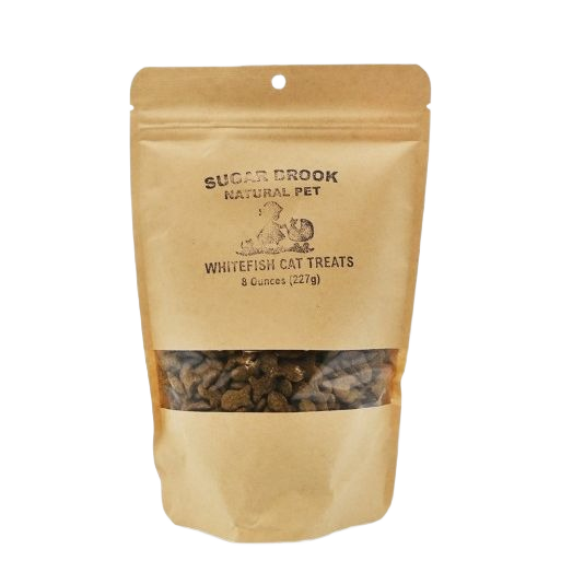 Brown resealable pouch of grain free whitefish cat treats from Sugar Brook Natural Pet with clear window showing treats inside