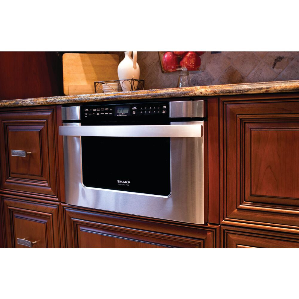 Built-in stainless steel microwave drawer installed in wooden cabinetry with digital control panel in kitchen appliances collection