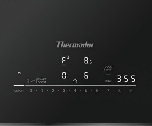 Close-up of digital control panel on a Thermador induction cooktop showing temperature, timer, and power boost settings, ideal for modern kitchens and kitchenware collections.