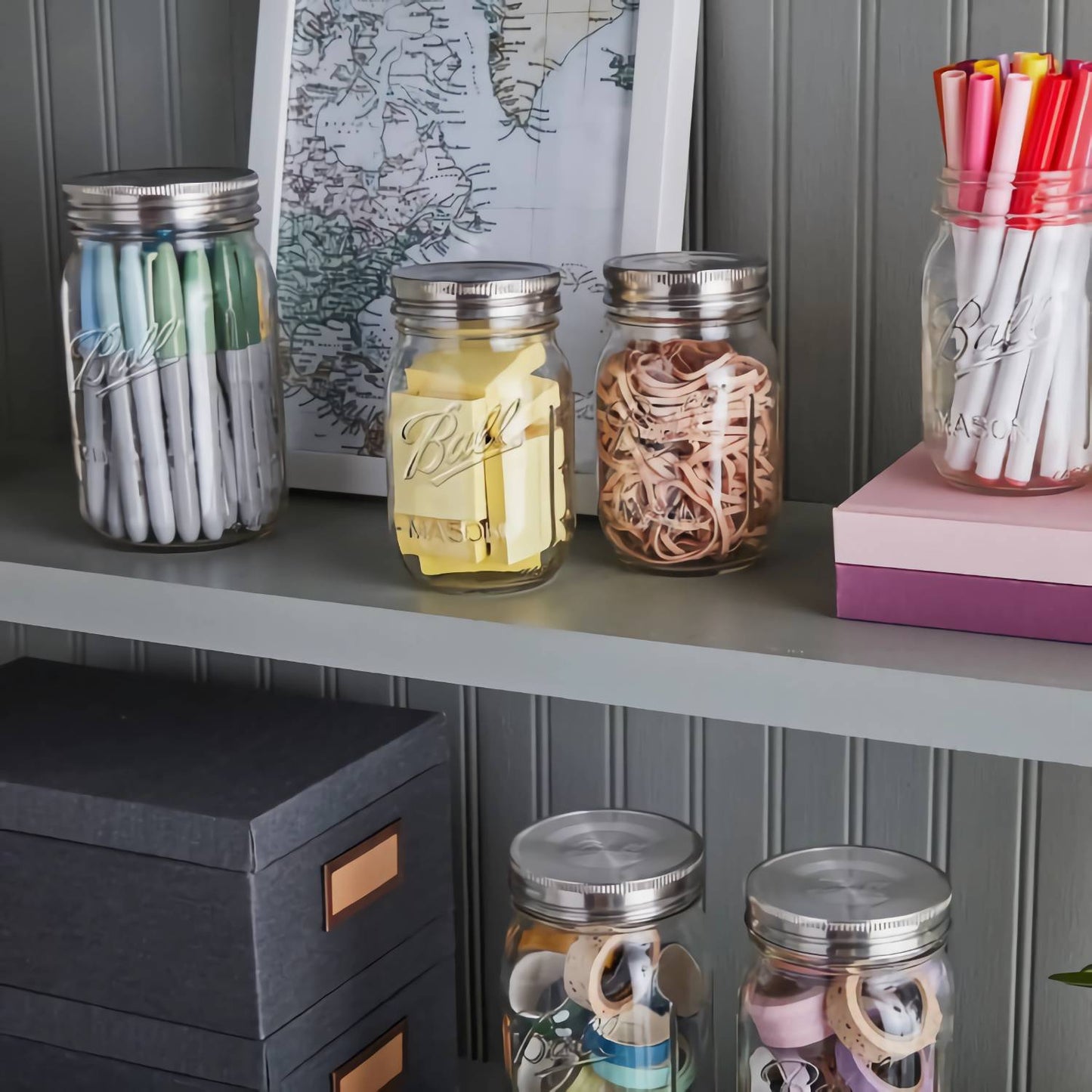 Set of three stainless steel storage lids on regular mouth jars, styled for kitchenware and home organization use