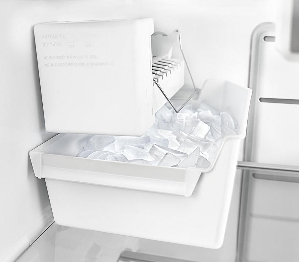 White interior ice maker bin with freshly made ice cubes inside an upright freezer, featured in Freezers & Ice Makers and Kitchen & Kitchenware collections.