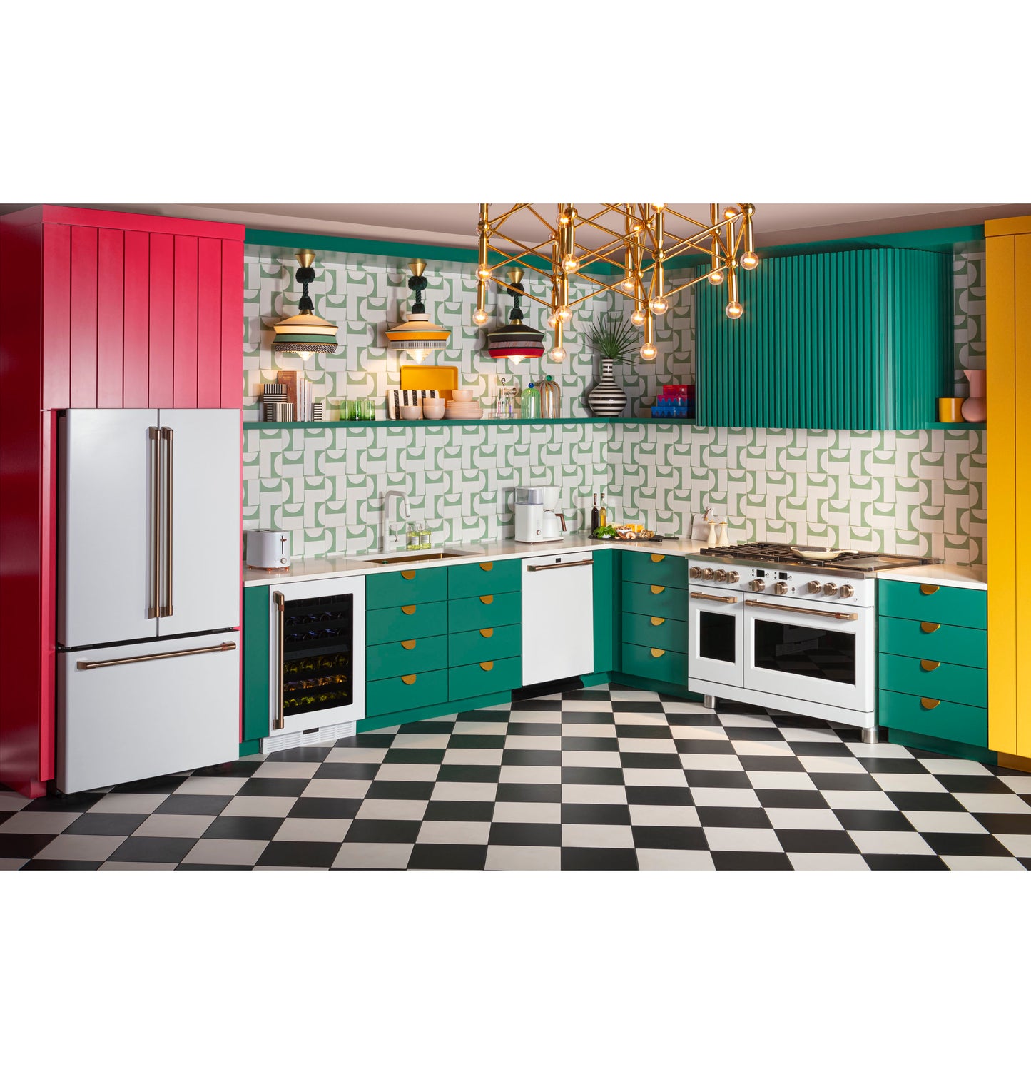 Bright kitchen with green and yellow cabinetry, white appliances, checkered black and white tile floor, and unique patterned backsplash