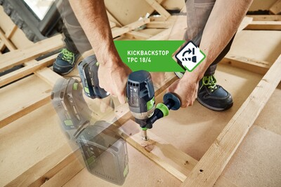 Person using Festool cordless hammer drill with side handle drilling into wooden studs during home improvement work