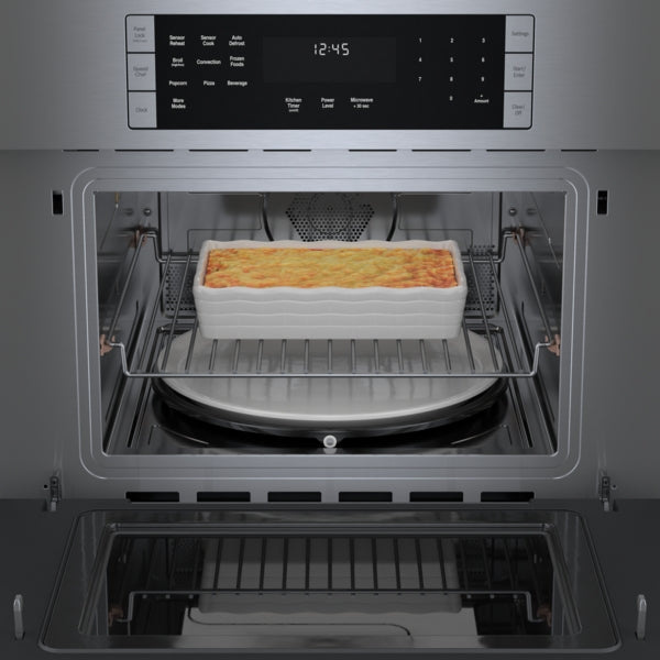 Stainless steel speed oven with digital display and casserole dish cooking inside in Bosch kitchen appliances collections