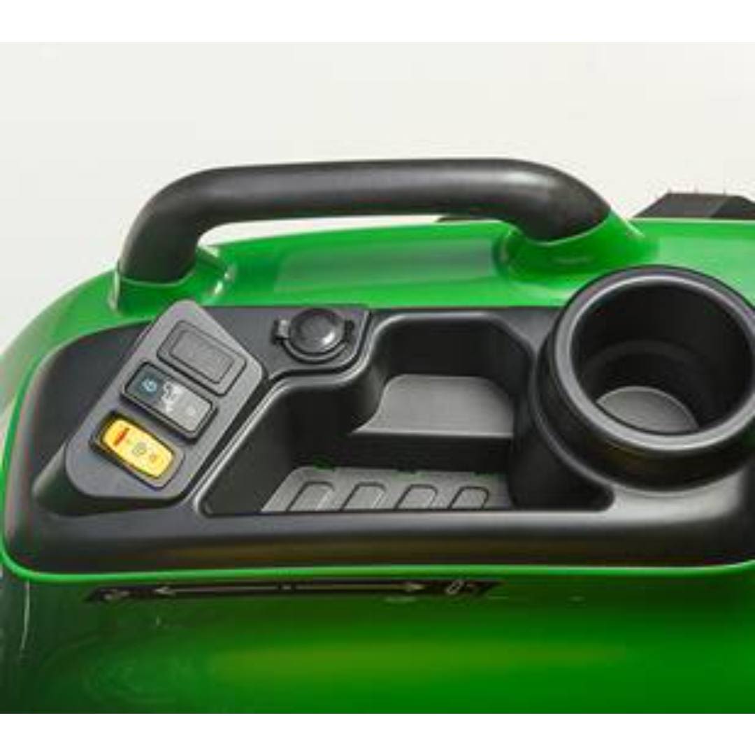 Control panel with switch buttons, power port, storage compartment, and cup holder on green tractor body