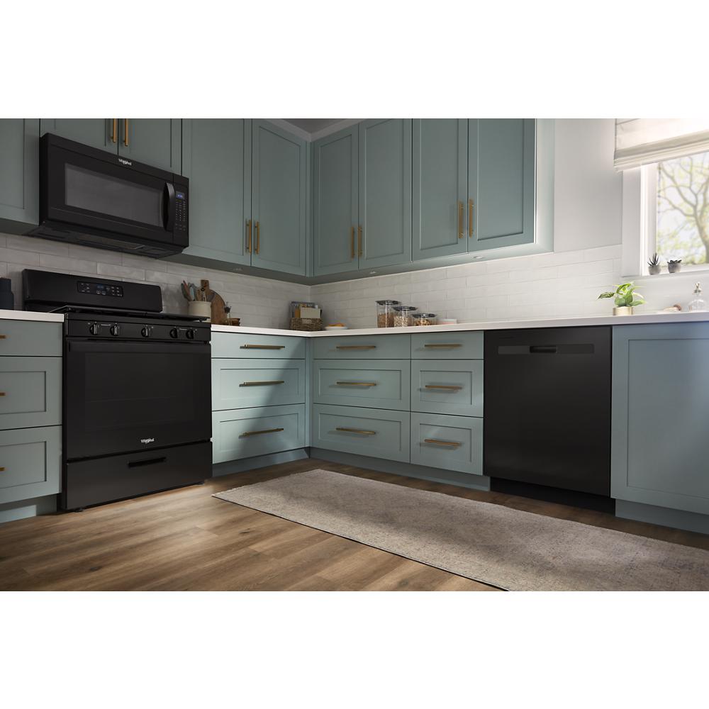 Modern kitchen with matte black appliances, light blue cabinetry, white countertops, and wood-look flooring in home improvement collection