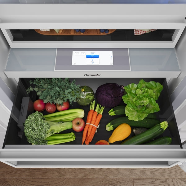 Open built-in bottom freezer drawer with fresh vegetables inside from Thermador appliances collection