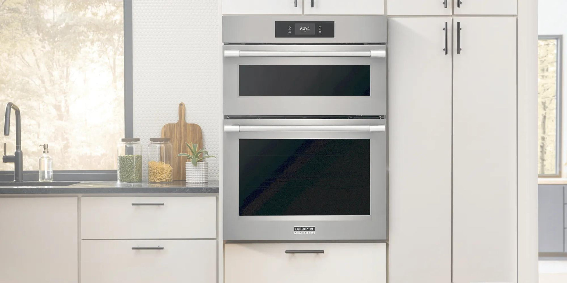 Brushed stainless steel wall oven and microwave combo with sleek digital control in modern kitchen setting