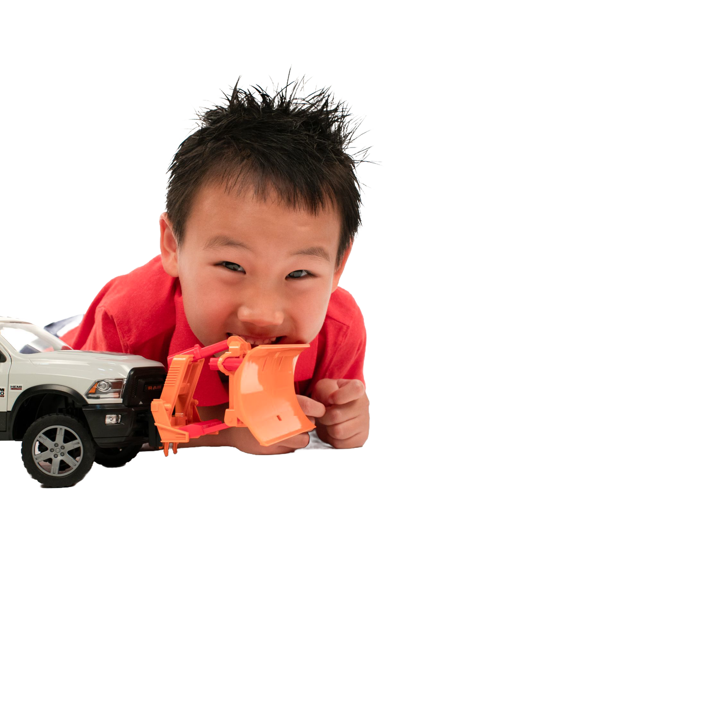 Child playing with white toy truck fitted with orange plow blade from Bruder Toys in Vehicles & Remote Controlled Toys collection
