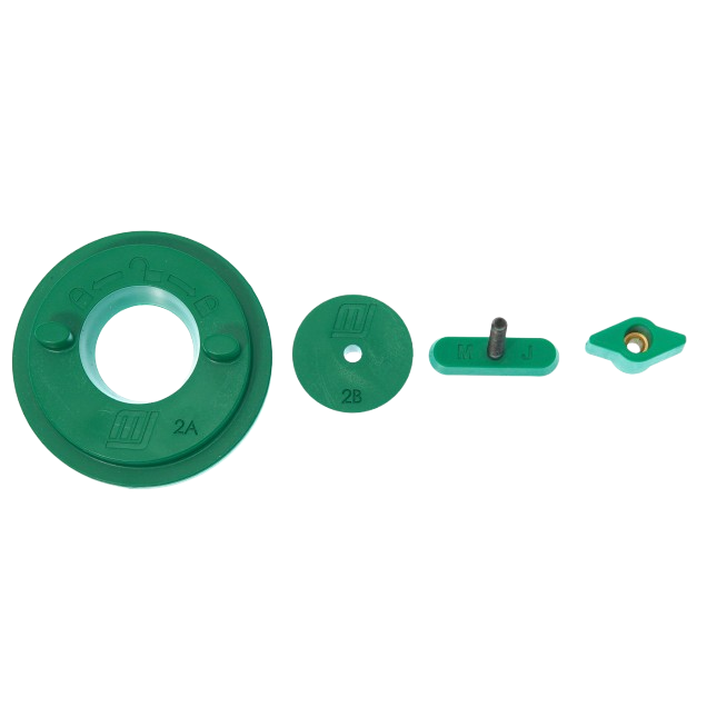 Set of green plastic accessory parts including discs and connectors for tool use in home improvement projects