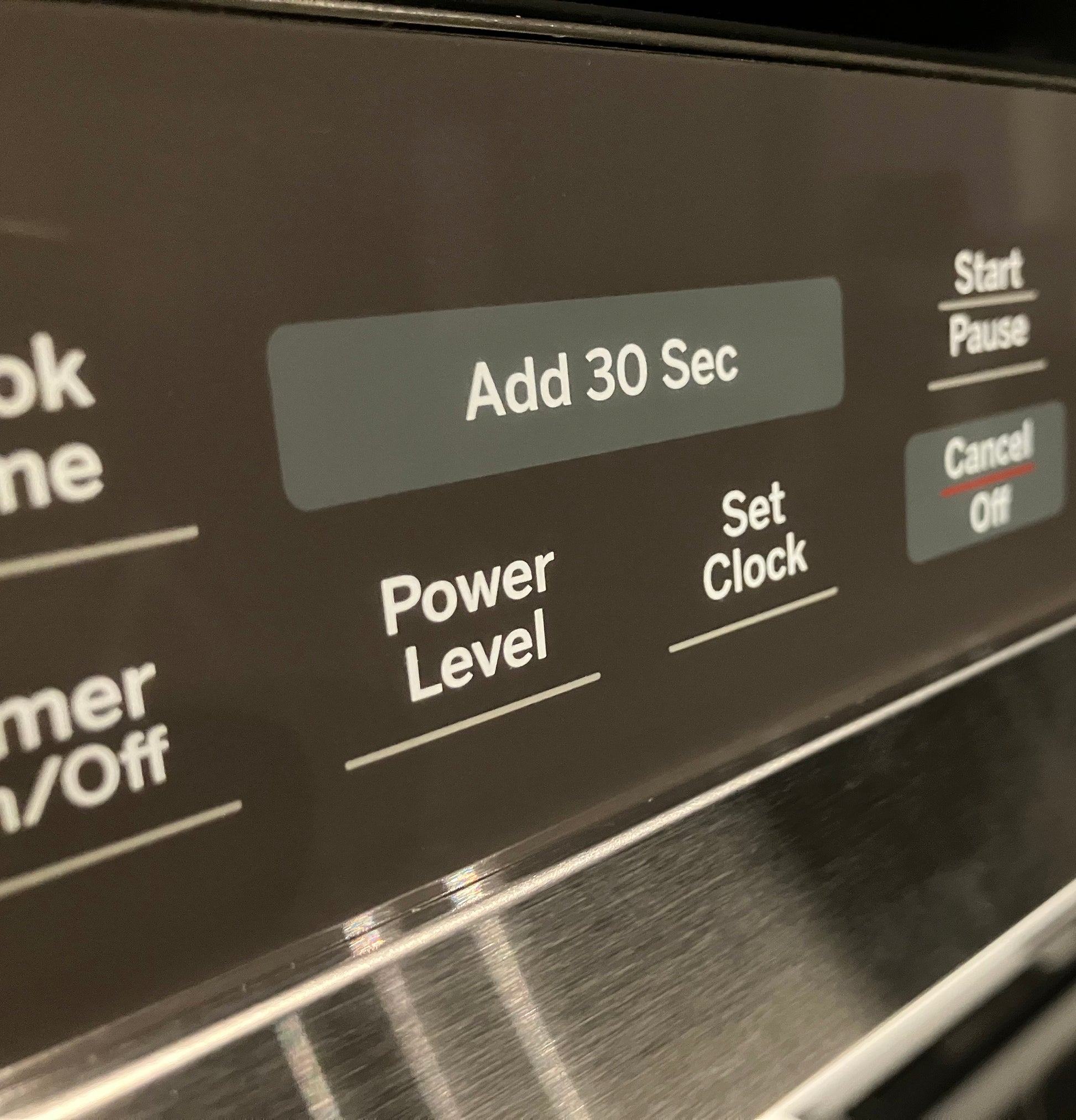 Close-up of control panel on sensor microwave showing Add 30 Sec, Power Level, Set Clock, Start Pause, and Cancel Off buttons