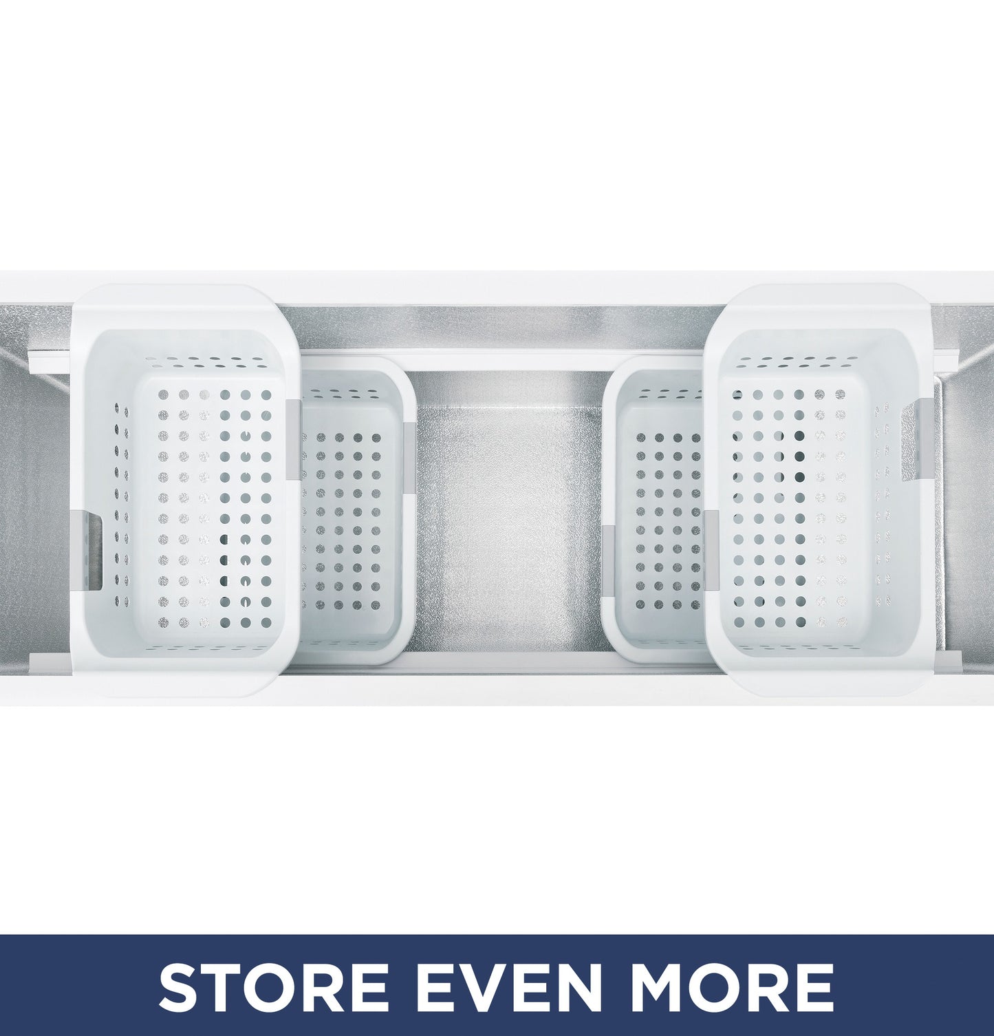 Top view inside manual defrost chest freezer showing four removable white storage baskets for organization.