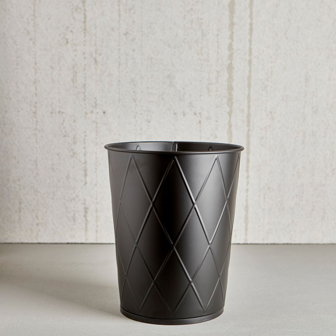 Black waste basket with harlequin pattern and wipe-clean surface for bathroom and bath collections under $50