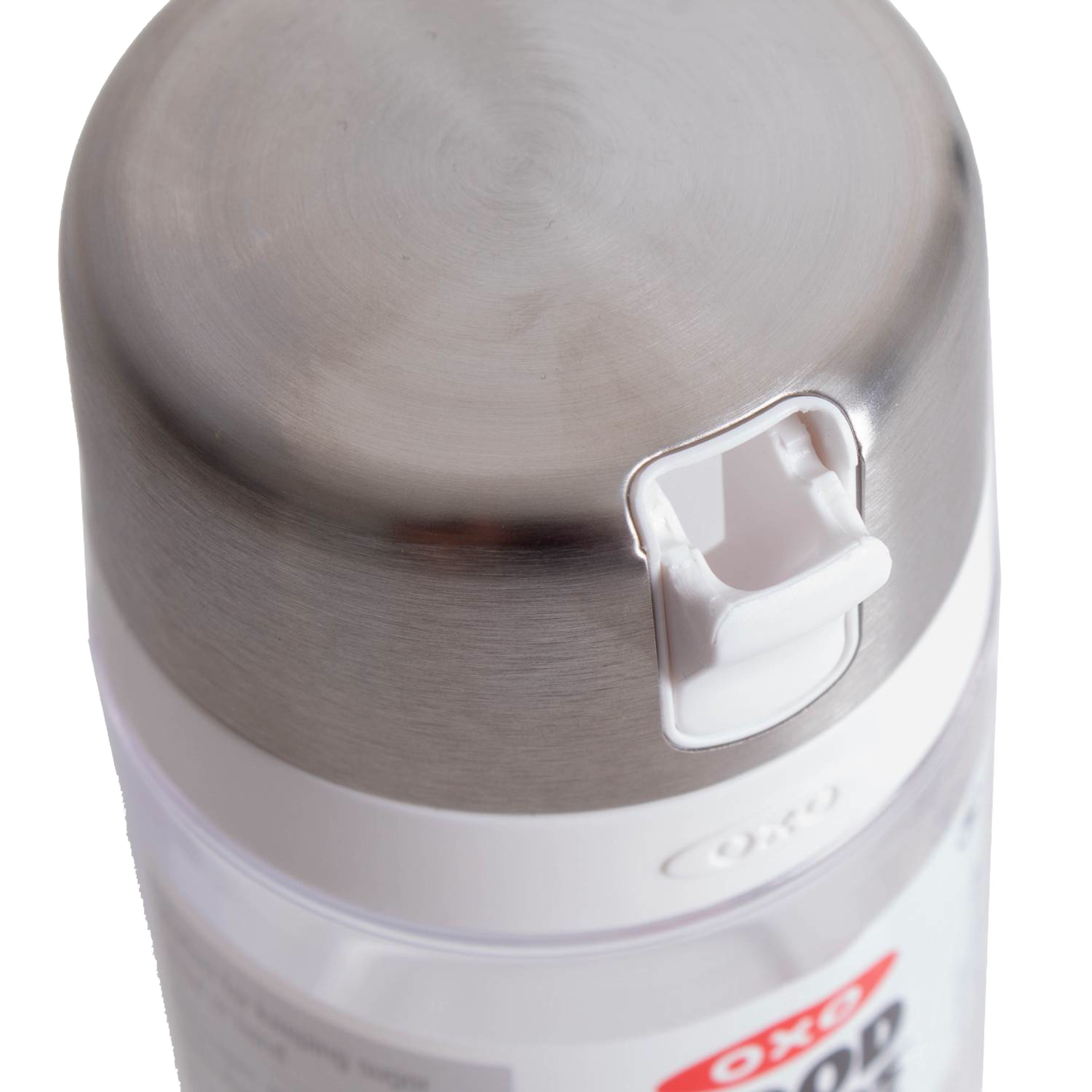 Close-up of stainless steel lid with white flip-top spout on clear sugar dispenser for kitchen storage and organization